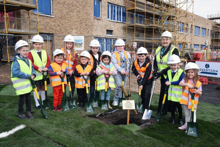 Prospective pupils planting a tree with Provost Anthea Dickson at the Montgomerie Park Primary School Topping Out event