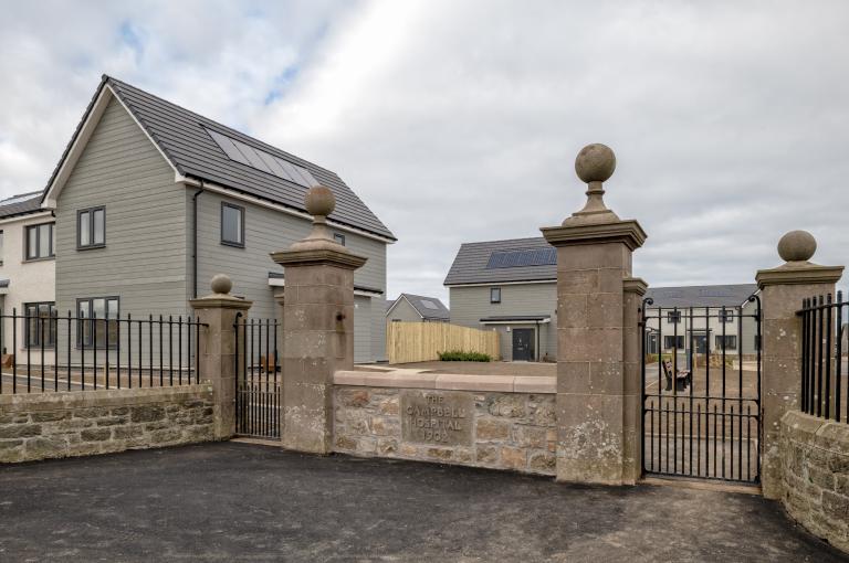 Social housing in Portsoy, Aberdeenshire, Scotland with historic wall from previous hospital site