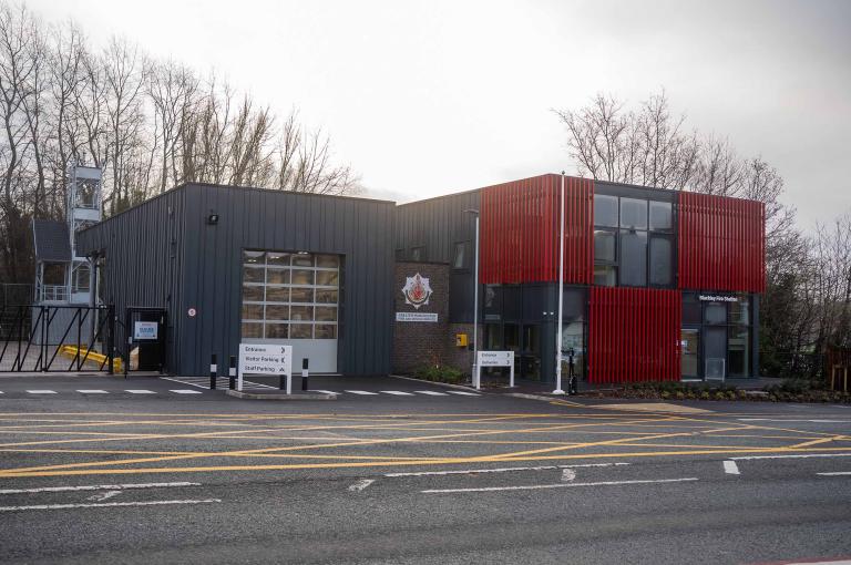 Image of fire station with dark grey and red cladding