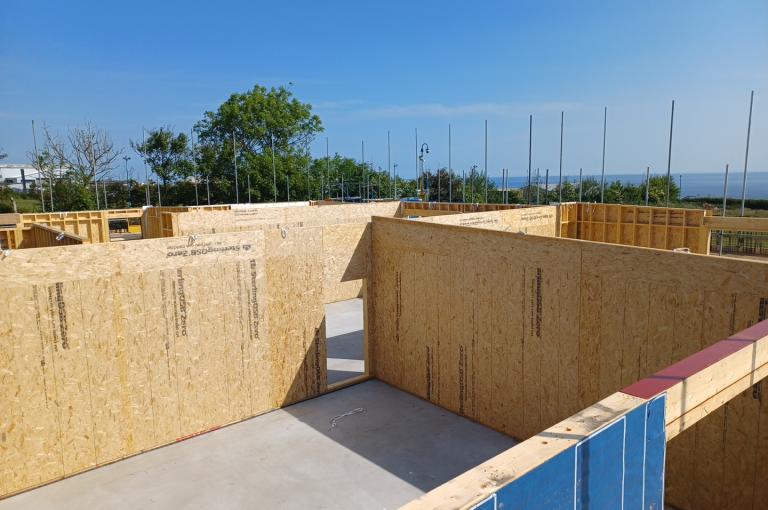 Commercial building under construction with prefabricated timber frame components