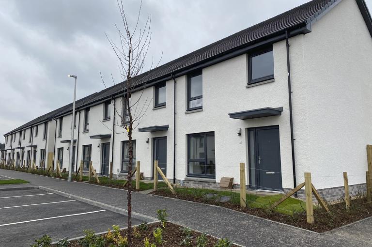 White render affordable homes at Dargavel Village built by Robertson