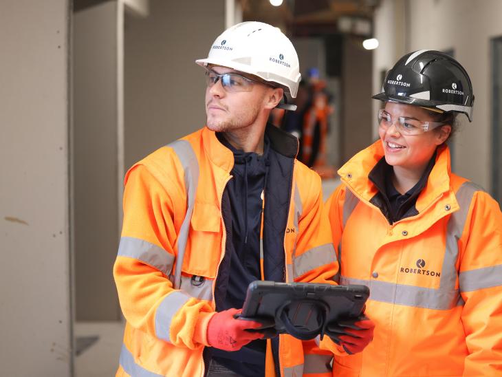 Two people on a construction site