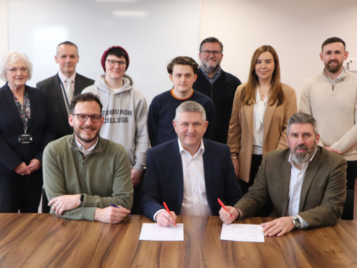Robertson Group and Edinburgh College individuals sat at a table signing a Memorandum of Understanding