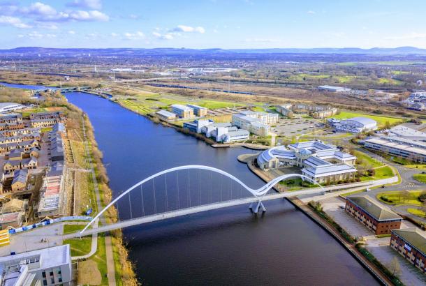 An aerial view of Teesside University on a sunny day with the iconic bridge in the foreground.