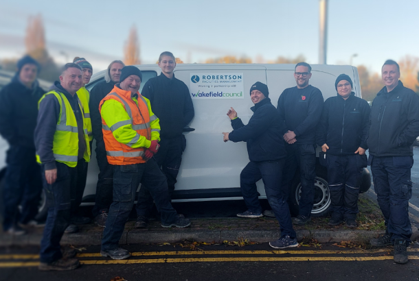 Robertson Facilities Management employees by the newly wrapped Wakefield Council and RFM van