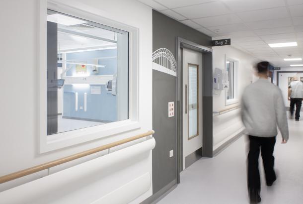 NHS staff member walking through a corridor at the Freeman Hospital, Newcastle