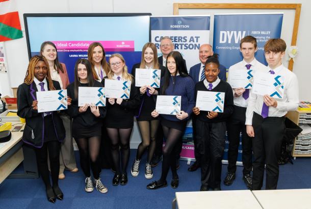School pupils holding certificates from Robertson Group's Ideal Candidate Programme
