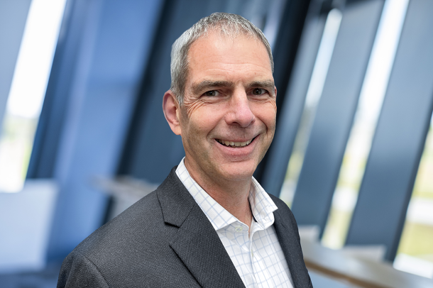 Image of a business man in grey suit jacket and white shirt