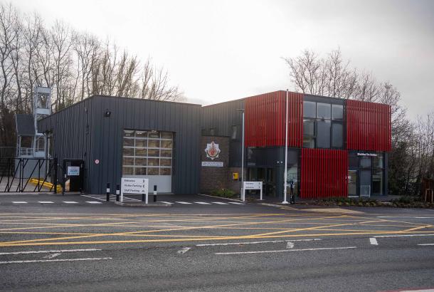 Image of fire station with dark grey and red cladding