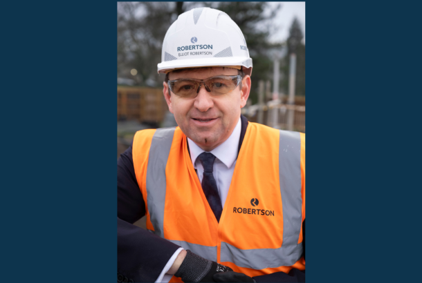 Robertson Group CEO Elliot Robertson in full PPE smiling at the Dollar Academy construction site