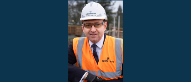 Robertson Group CEO Elliot Robertson in full PPE smiling at the Dollar Academy construction site