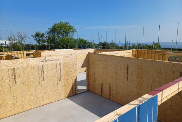Commercial building under construction with prefabricated timber frame components