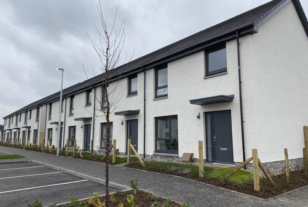 White render affordable homes at Dargavel Village built by Robertson