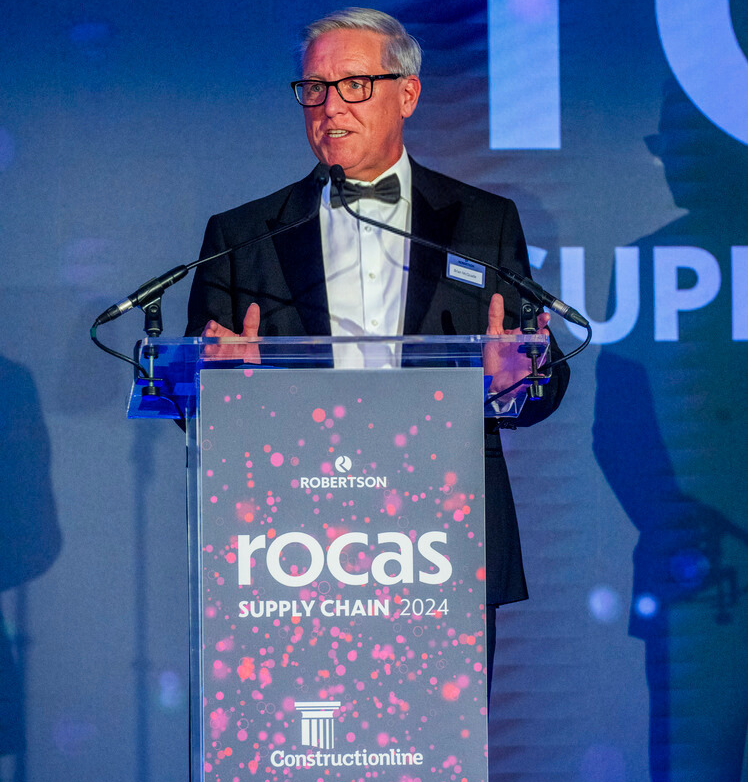 Chief Operating Officer Brian McQuade presenting behind a podium at the Robertson Supply Chain Outstanding Contribution Awards 2024