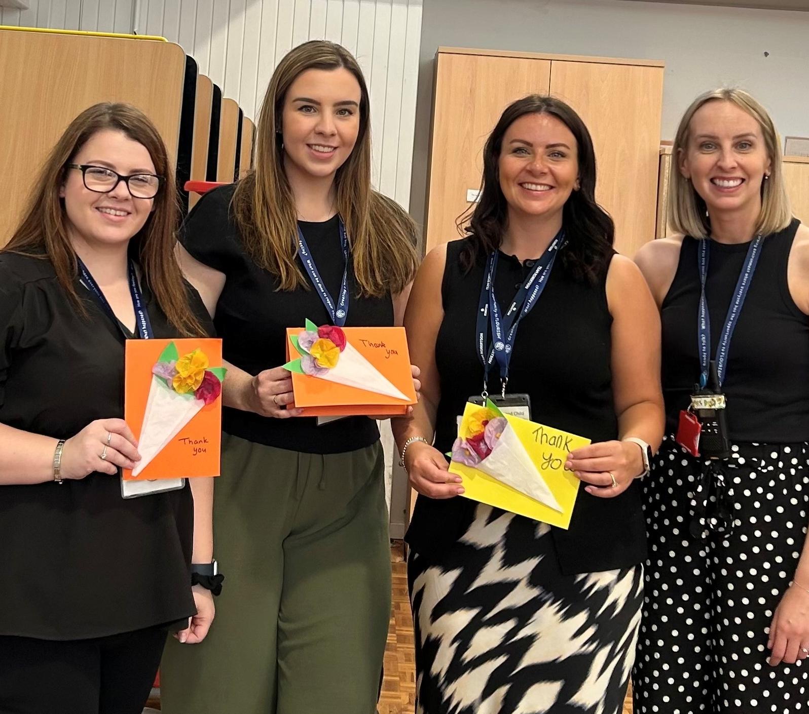 Image of Robertson staff holding gifts from pupils