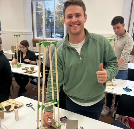 Robertson employee smiling with STEM build