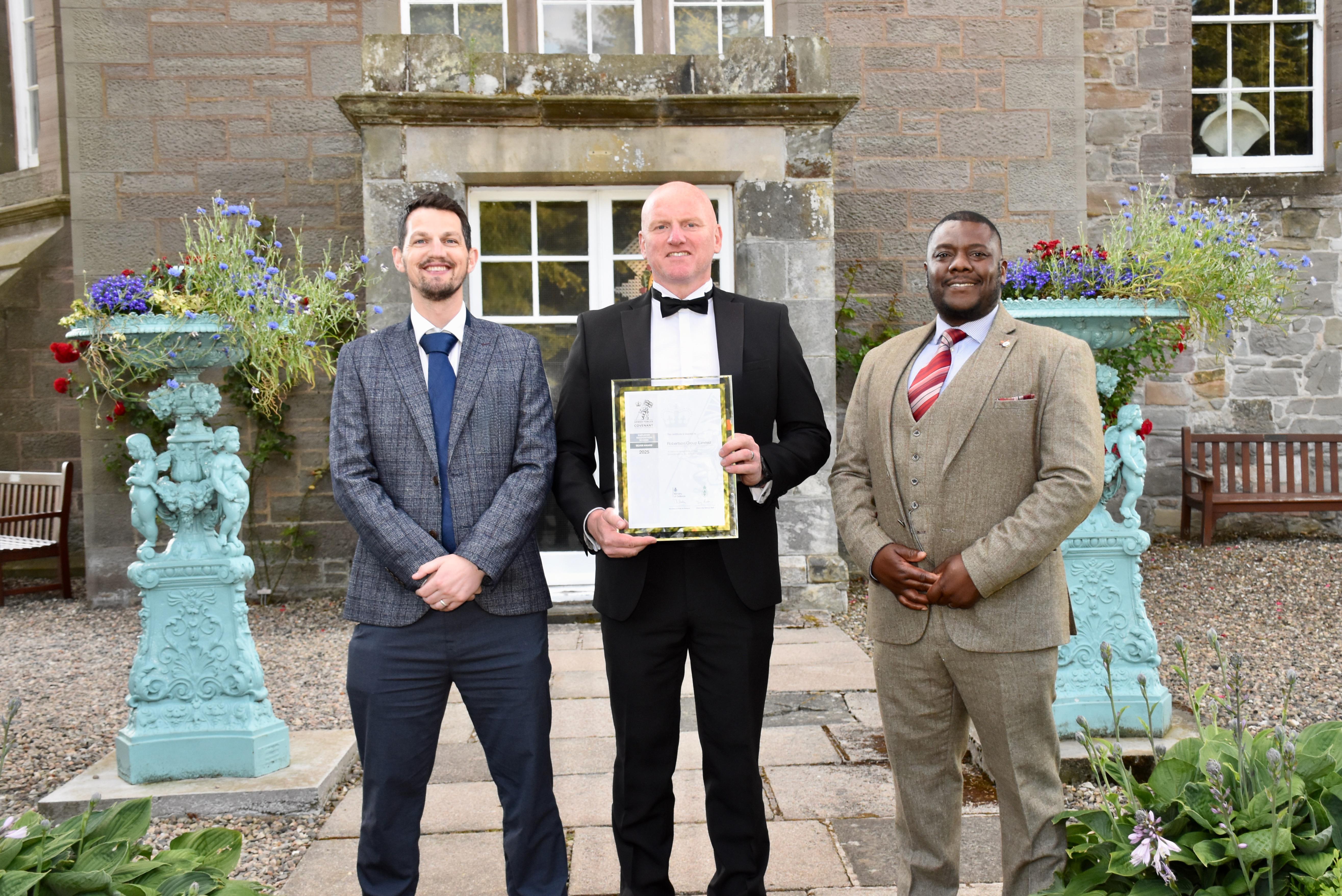 Robertson Group employees collecting the Armed Forces Covenant ERS SIlver Award