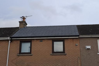 roof on a red rendered house
