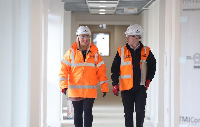 Robertson Construction site team members walking down corridor.
