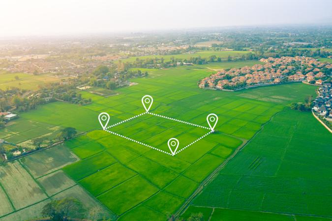 A an aerial large area of ground with a white outline, depicting where work will begin.