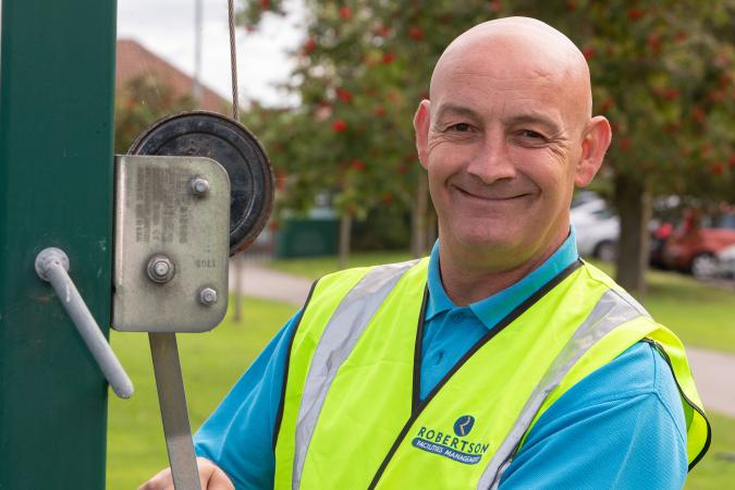 One of Robertson Facilities Management's grounds maintenance team members.