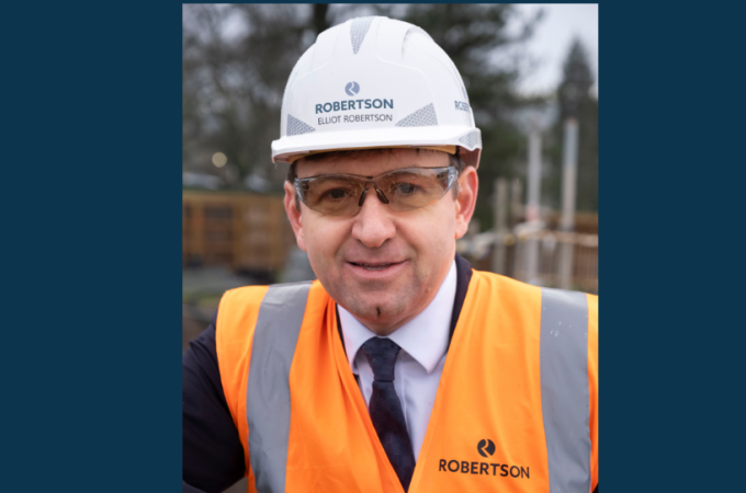 Robertson Group CEO Elliot Robertson in full PPE smiling at the Dollar Academy construction site