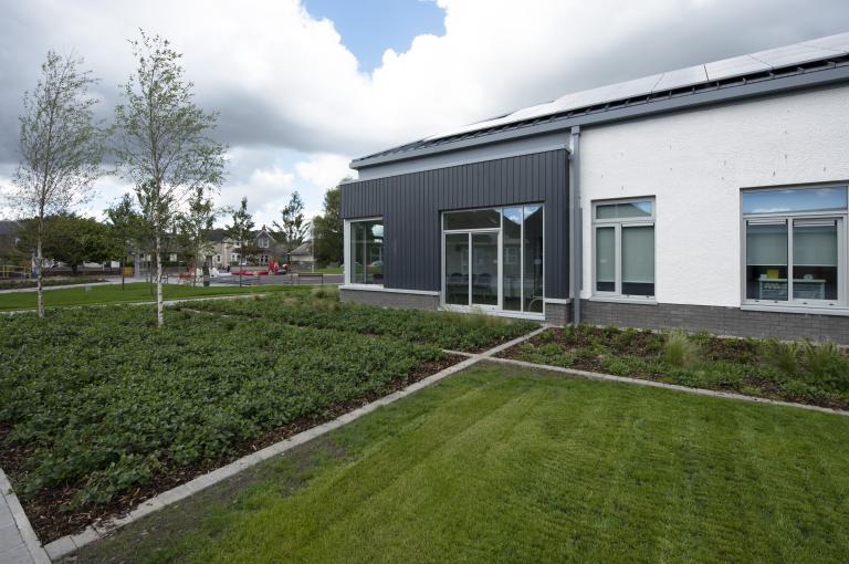 The exterior of Stirling Health and Care Village, showing the building and grounds.