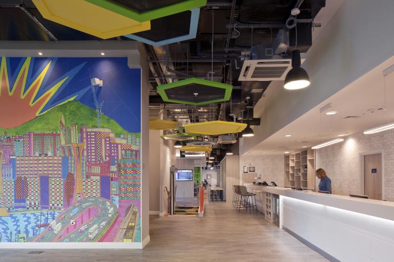 Reception area with colourful mural of city scape
