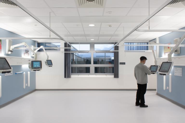 NHS staff member using a fixed tablet screen within the Freeman Hospital, Newcastle, where Robertson Construction North East delivered a strategic refurbishment