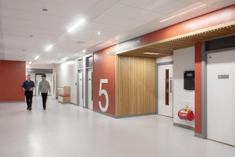 NHS staff members walking through the corridor of the Freeman Hospital, Newcastle, where Robertson Construction North East delivered a strategic refurbishment