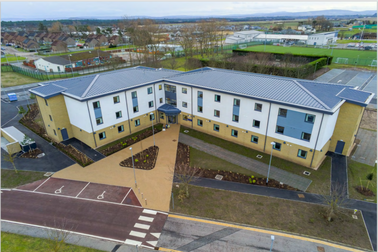 Aerial picture of accommodation building at RAF Lossiemouth with blue sky