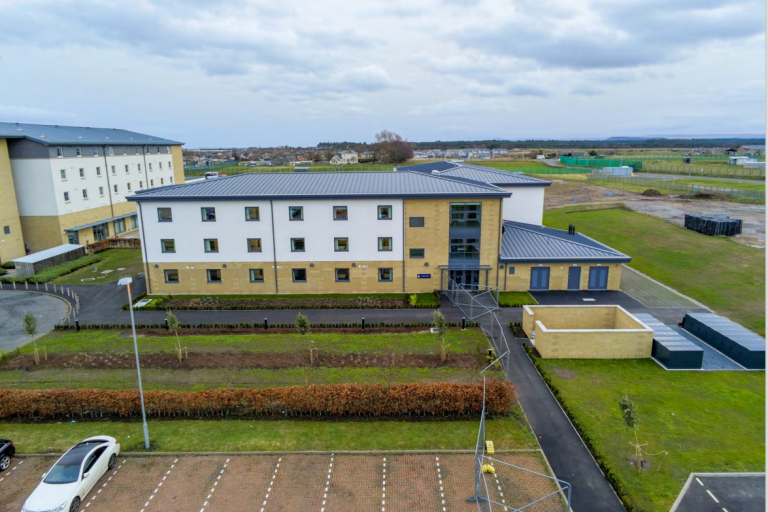 Aerial picture of accommodation building at RAF Lossiemouth with blue sky