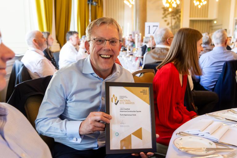 Man holding an award certificate
