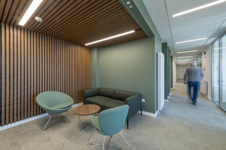 Breakout space with seating and a table within an educational science buiding