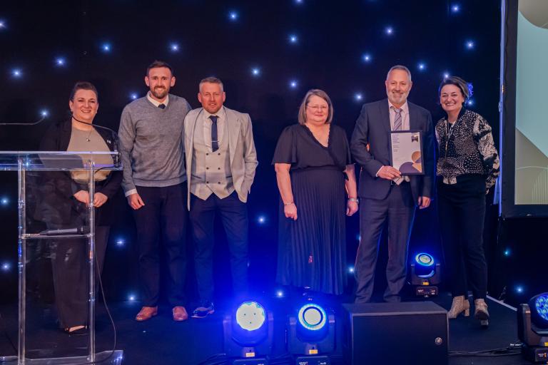 People from Robertson Group holding certificates from the CCS National Site Awards