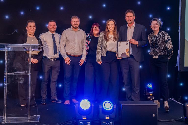 People from Robertson Group holding certificates from the CCS National Site Awards