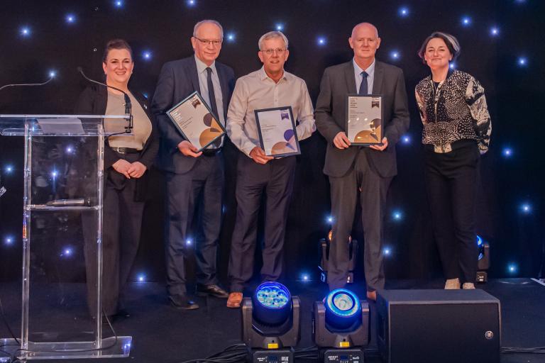People from Robertson Group holding certificates from the CCS National Site Awards