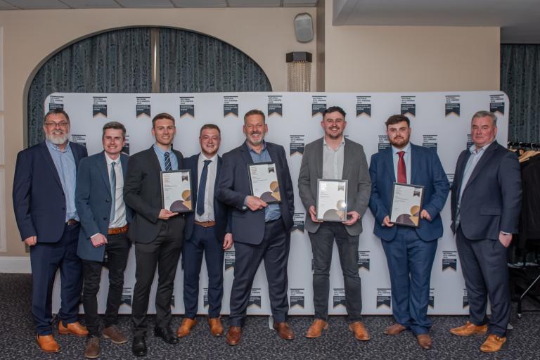 People from Robertson Group holding certificates from the CCS National Site Awards
