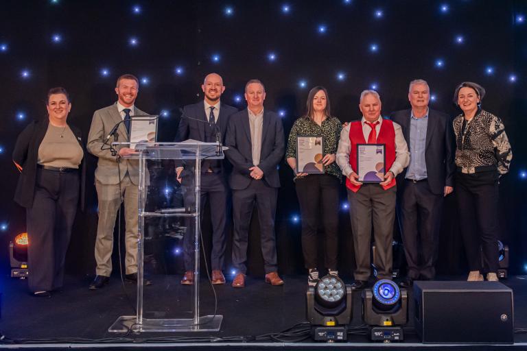 People from Robertson Group holding certificates from the CCS National Site Awards