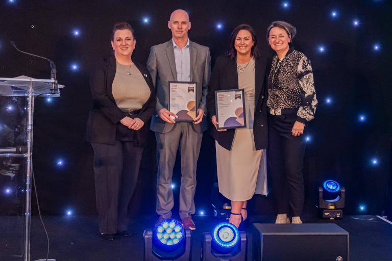 People from Robertson Group holding certificates from the CCS National Site Awards