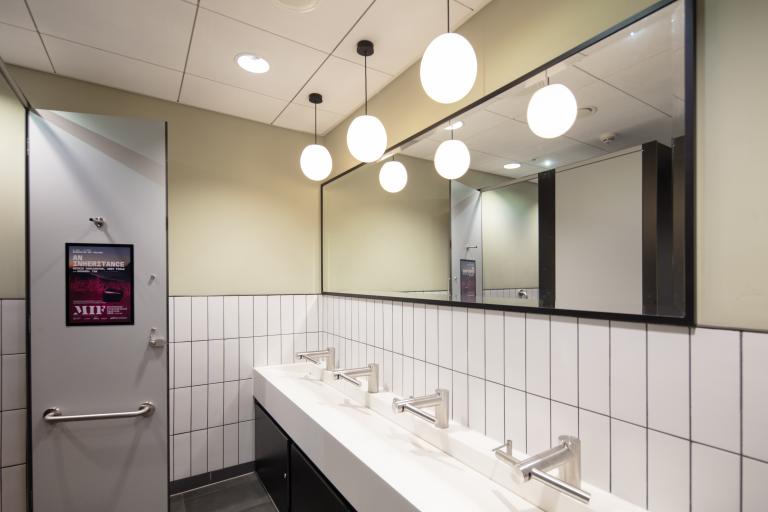 Image of restroom interior with mirror and sinks