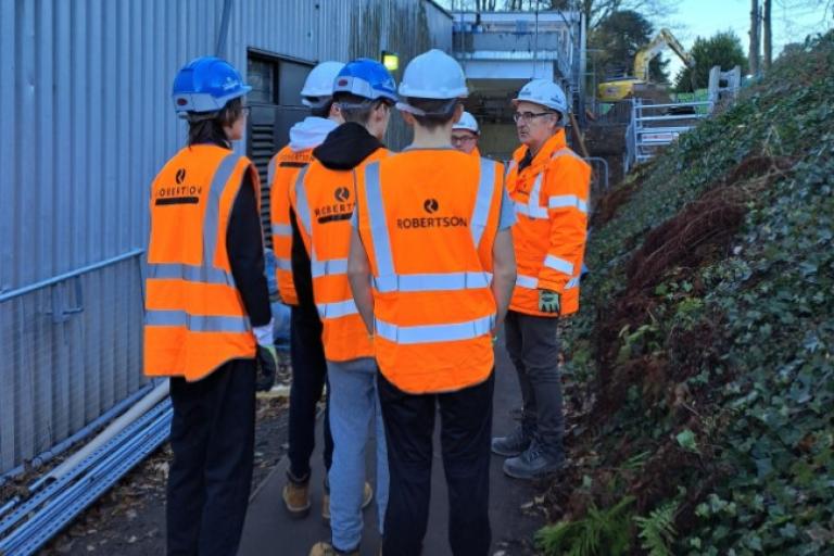 Young people receiving a tour of a construction site