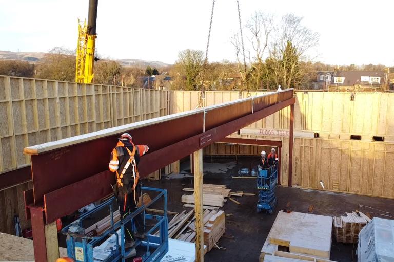 Hybrid construction with steel beam and mass timber