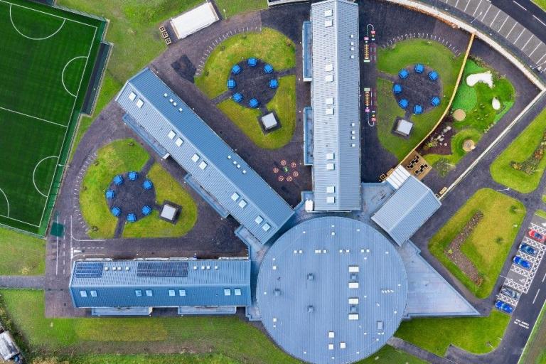 Aerial view of completed school with wings