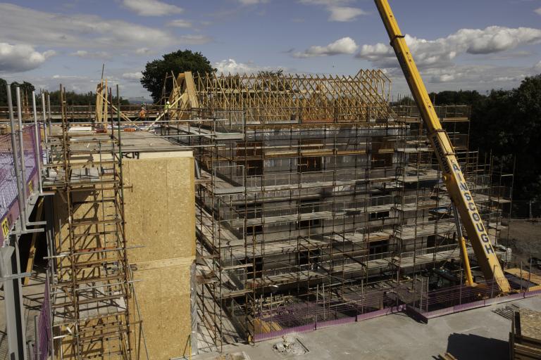 Timber roof trusses being craned into place