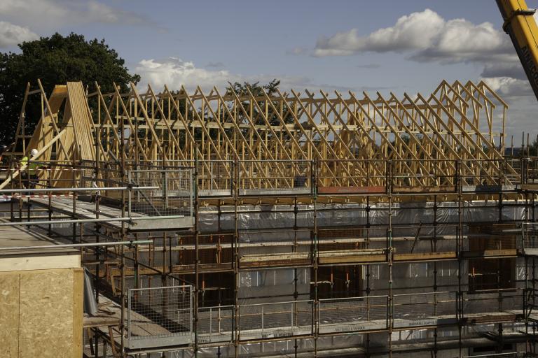 Timber roof trusses being craned into place