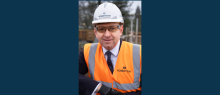 Robertson Group CEO Elliot Robertson in full PPE smiling at the Dollar Academy construction site