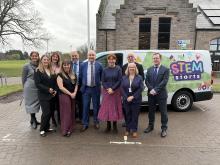 Robertson Construction, Moray Council and Scottish Government representatives stood outside together in front of a green and white van with the STEM Starts logo, announcing its launch and the official opening of Elgin's EY STEM Centre