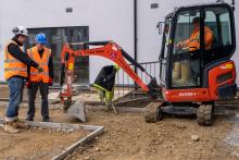 Image shows Robertson site manager Kieran Pemberton (far left), and Damien Lee (far right) from Hewitson Limited with Jack Grainger (middle), who completed a work placement at the Hebburn development with Robertson before securing a position with Hewitson as a trainee site manager.