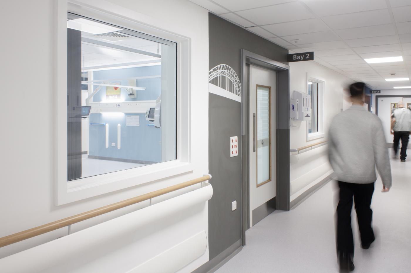 NHS staff member walking through a corridor at the Freeman Hospital, Newcastle